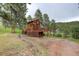 A charming mountain home with a wrap-around deck, and a drive-under garage at 13190 Coyote Song Trl, Conifer, CO 80433