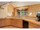 Bright kitchen featuring wood cabinets, countertops, and a window overlooking wooded scenery at 13190 Coyote Song Trl, Conifer, CO 80433