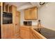 Well-equipped kitchen with wood cabinets, electric cooktop, and built-in microwave at 13190 Coyote Song Trl, Conifer, CO 80433
