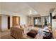 Spacious living room featuring a sectional sofa and sliding door to the outside at 13190 Coyote Song Trl, Conifer, CO 80433