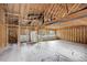 Unfinished living room with exposed beams and natural light at 13190 Coyote Song Trl, Conifer, CO 80433
