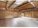 Unfinished room with exposed beams and wood flooring offers potential at 13190 Coyote Song Trl, Conifer, CO 80433