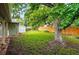 Spacious backyard featuring a manicured lawn, tall trees, shed, and wooden fence at 6874 S Detroit Cir, Centennial, CO 80122
