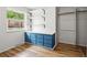 Bedroom closet features custom built-in shelving and blue drawers, a window, and hardwood floors at 6874 S Detroit Cir, Centennial, CO 80122