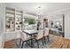 Open concept dining area with built-in shelving and a large window overlooking the front yard at 6874 S Detroit Cir, Centennial, CO 80122