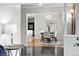 Open-concept dining room with hardwood floors, modern lighting, and a view to the kitchen and living room at 6874 S Detroit Cir, Centennial, CO 80122