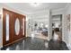 Spacious foyer featuring slate flooring, wood and glass front door, and views of the living areas at 6874 S Detroit Cir, Centennial, CO 80122