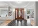 Welcoming foyer with slate floors, a wooden door with glass inlay, and a view into the living spaces at 6874 S Detroit Cir, Centennial, CO 80122