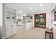 Spacious kitchen with white cabinets, an island, and sliding glass doors to the backyard at 6874 S Detroit Cir, Centennial, CO 80122