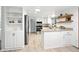 Bright kitchen with white cabinets, stainless steel appliances, and open shelving at 6874 S Detroit Cir, Centennial, CO 80122
