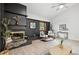 Charming living room featuring a black brick fireplace, vaulted ceiling, and natural light at 6874 S Detroit Cir, Centennial, CO 80122