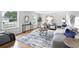 Sunlit living room featuring hardwood floors, neutral paint, stylish furniture and an expansive window at 6874 S Detroit Cir, Centennial, CO 80122