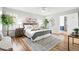 A bright main bedroom with hardwood floors, fan, stylish decor, and natural light at 6874 S Detroit Cir, Centennial, CO 80122