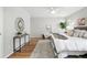 Well decorated main bedroom with hardwood floors, stylish console table, and lots of natural light at 6874 S Detroit Cir, Centennial, CO 80122