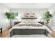 A nicely decorated main bedroom with hardwood floors, modern decor, and plenty of natural light at 6874 S Detroit Cir, Centennial, CO 80122