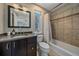 Clean bathroom with tub, shower, and dark brown vanity at 3323 W Hayward Pl, Denver, CO 80211