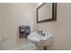 Small bathroom with pedestal sink and mirror at 3323 W Hayward Pl, Denver, CO 80211