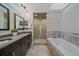 Elegant bathroom with double vanity, soaking tub, and separate shower at 3323 W Hayward Pl, Denver, CO 80211