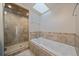 Spa-like bathroom with a large soaking tub and walk-in shower at 3323 W Hayward Pl, Denver, CO 80211