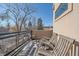 Relaxing deck with wooden chairs, offering views of the neighborhood at 3323 W Hayward Pl, Denver, CO 80211