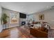 Spacious living room with a stone fireplace and hardwood floors at 3323 W Hayward Pl, Denver, CO 80211