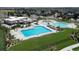 Aerial view of the community pool, playground, and amenity center surrounded by neighborhood homes at 4599 Windmill Dr, Brighton, CO 80601