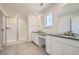 Elegant bathroom with a walk-in shower, dual sinks, and modern countertops at 4599 Windmill Dr, Brighton, CO 80601