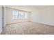 Spacious bedroom with plush carpeting, large window, and ample natural light at 4599 Windmill Dr, Brighton, CO 80601