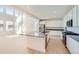 Bright, open kitchen with stainless appliances, large island, and adjacent living area at 4599 Windmill Dr, Brighton, CO 80601