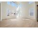Bright living room boasting soaring ceilings, large windows, and beautiful hardwood floors at 4599 Windmill Dr, Brighton, CO 80601