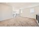 Bright loft space with neutral carpeting and natural light from multiple windows at 4599 Windmill Dr, Brighton, CO 80601