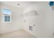 Laundry room with overhead shelving and window at 11425 Booth Falls Ct, Parker, CO 80134