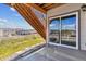 Back patio with sliding glass doors and stone steps leading to the backyard at 4992 Trails Edge Ln, Castle Rock, CO 80104