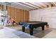 Unfinished basement featuring concrete floors, exposed utilities, and a pool table covered by a black tarp at 4992 Trails Edge Ln, Castle Rock, CO 80104