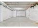Unfinished basement with open layout, concrete floors, and white-wrapped walls at 4992 Trails Edge Ln, Castle Rock, CO 80104