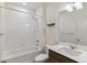 Bathroom featuring white tiles, a shower-tub combo, and a modern vanity with lots of light at 4992 Trails Edge Ln, Castle Rock, CO 80104