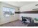 Bright bedroom featuring a work space, a large window, and neutral tones with pops of brown at 4992 Trails Edge Ln, Castle Rock, CO 80104