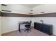 Bedroom with an office space, floating shelves, dark wood accents, and carpeted floor at 4992 Trails Edge Ln, Castle Rock, CO 80104