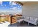 Relaxing deck area with a comfortable sofa and scenic views of the neighborhood at 4992 Trails Edge Ln, Castle Rock, CO 80104