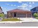 Charming ranch home featuring a three-car garage and brick exterior, set against a blue sky at 4992 Trails Edge Ln, Castle Rock, CO 80104