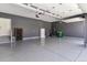 Spacious three car garage with epoxy flooring, storage cabinets, and modern fixtures at 4992 Trails Edge Ln, Castle Rock, CO 80104