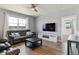 Cozy living room with a black leather couch, modern ceiling fan, and lots of natural light at 4992 Trails Edge Ln, Castle Rock, CO 80104
