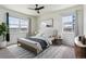 Bright bedroom with large windows, neutral decor, and a comfortable queen-size bed with stylish rug at 4992 Trails Edge Ln, Castle Rock, CO 80104