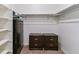 Well-organized walk-in closet with shelving units, hanging rods, and dark wooden dressers at 4992 Trails Edge Ln, Castle Rock, CO 80104