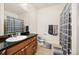 Bathroom with granite countertops, ceramic tile flooring and modern shower curtain at 4100 Albion St # 612, Denver, CO 80216