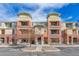Beautiful condominium building with brick and tan siding and parking spaces, inviting curb appeal at 4100 Albion St # 612, Denver, CO 80216