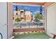 Cozy outdoor patio with artificial turf, furniture, and views of the parking lot and building facade at 4100 Albion St # 612, Denver, CO 80216