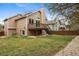 Spacious backyard with wooden deck, lawn, and mature trees at 6425 Nassau Ct, Highlands Ranch, CO 80130