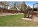 Large backyard featuring mature trees, lawn, wooden fence and stairs at 6425 Nassau Ct, Highlands Ranch, CO 80130