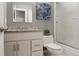 Clean bathroom featuring granite counters, white cabinets, and a tiled shower at 6425 Nassau Ct, Highlands Ranch, CO 80130